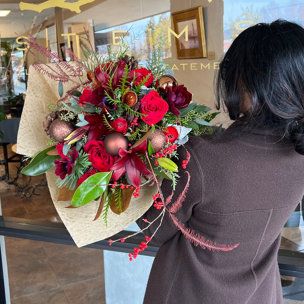 Hand-Wrapped Bouquet featuring Christmas greens and ornaments