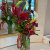 Compact and eclectic floral mix, square glass vase