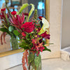 Compact and eclectic floral mix, square glass vase